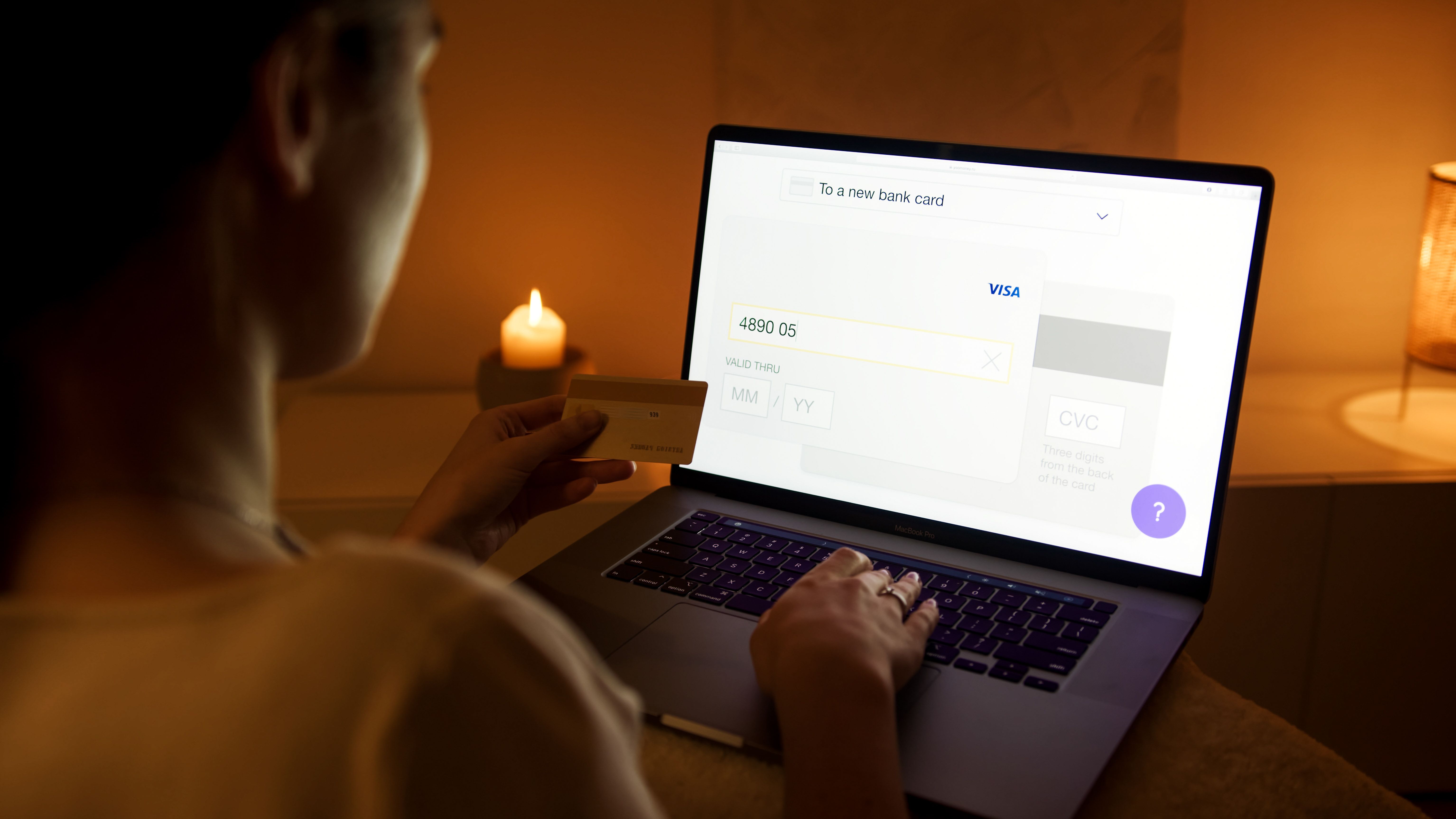 Woman paying online with a laptop and credit card, illustrating privacy-conscious digital transactions.